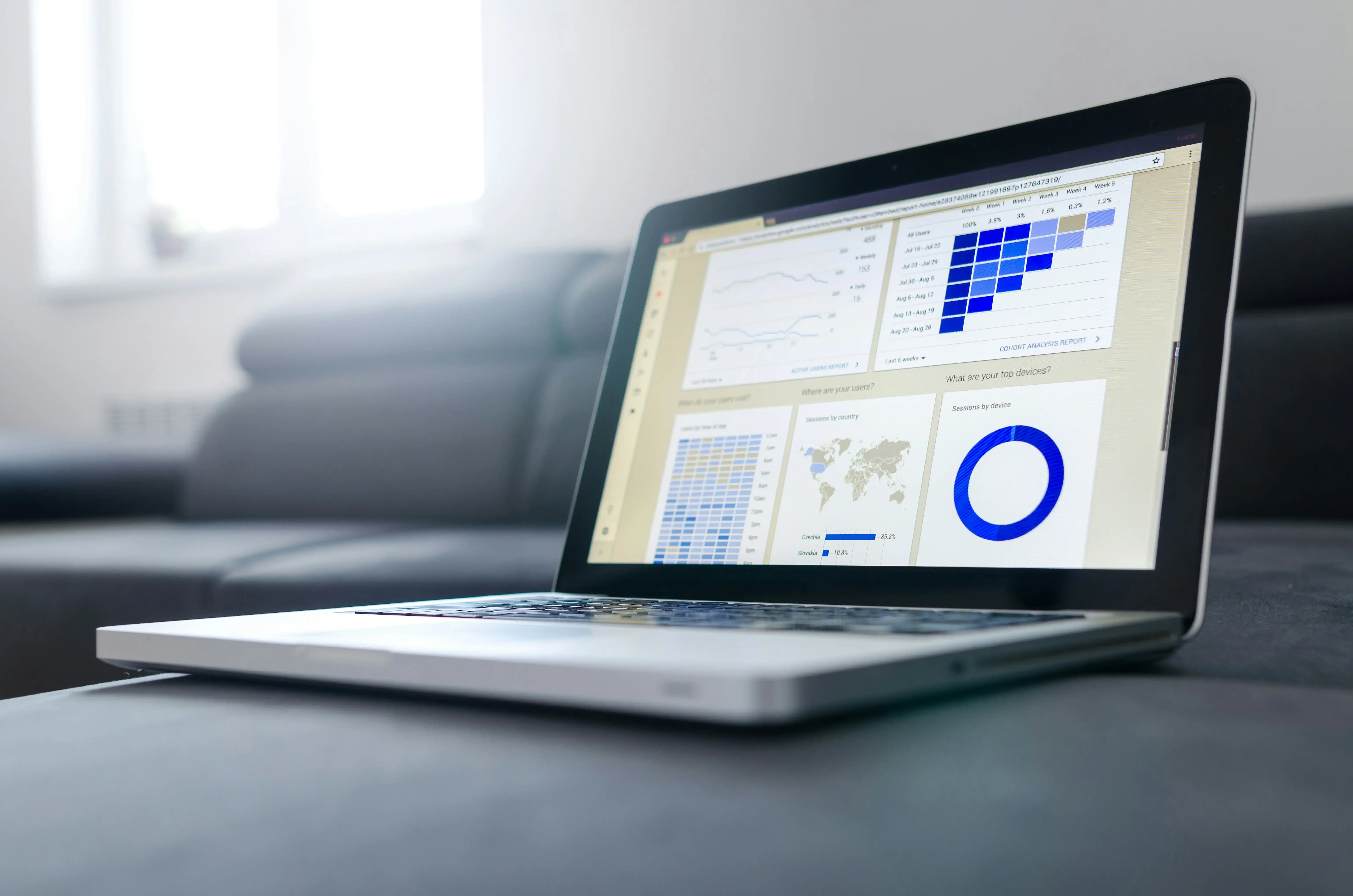 Modern workspace with laptop showing Ahrefs dashboard featuring site health scores, backlink metrics, and keyword rankings