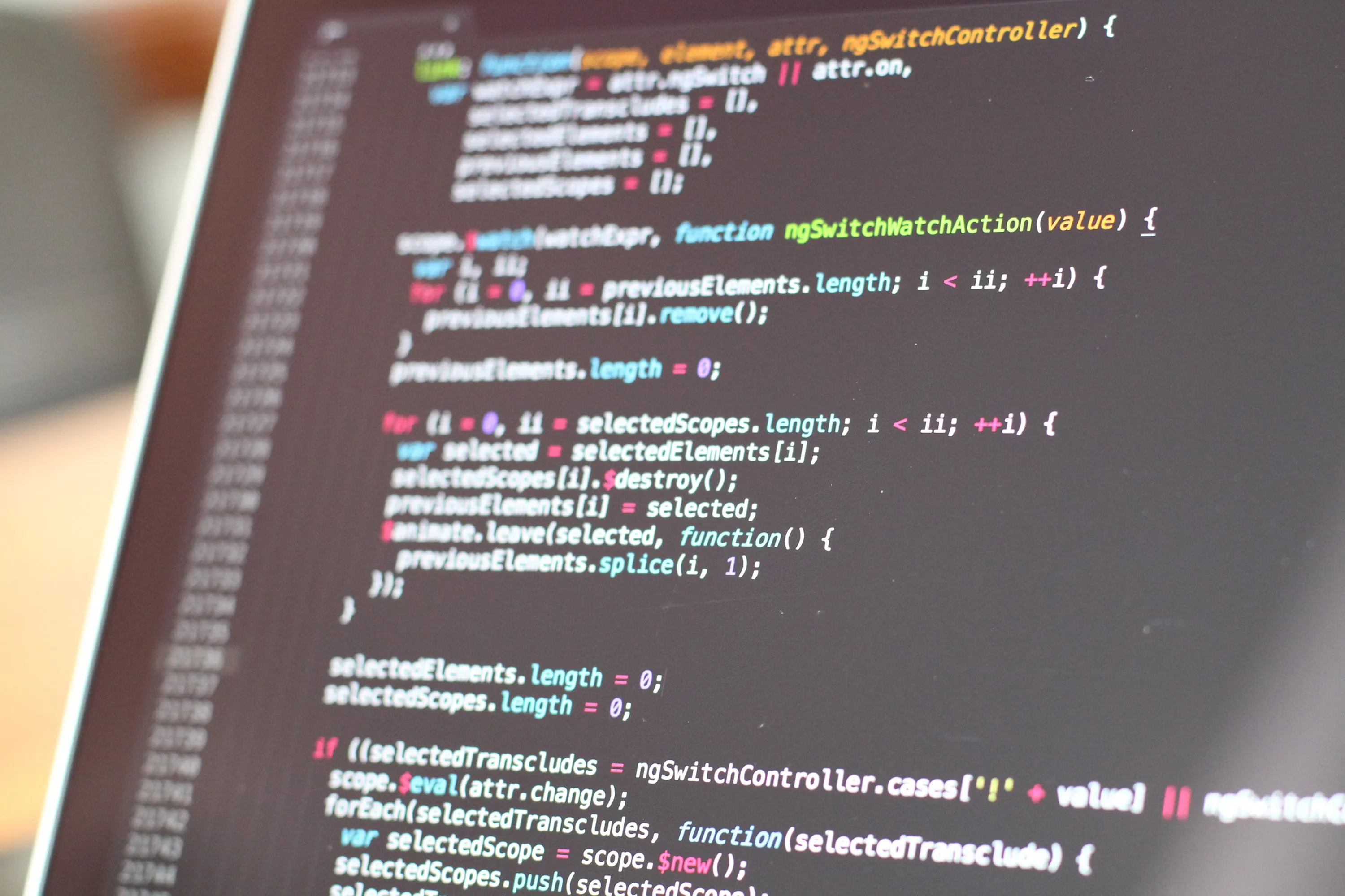 Colorful code on laptop screen showing HTML and CSS markup for mobile optimization